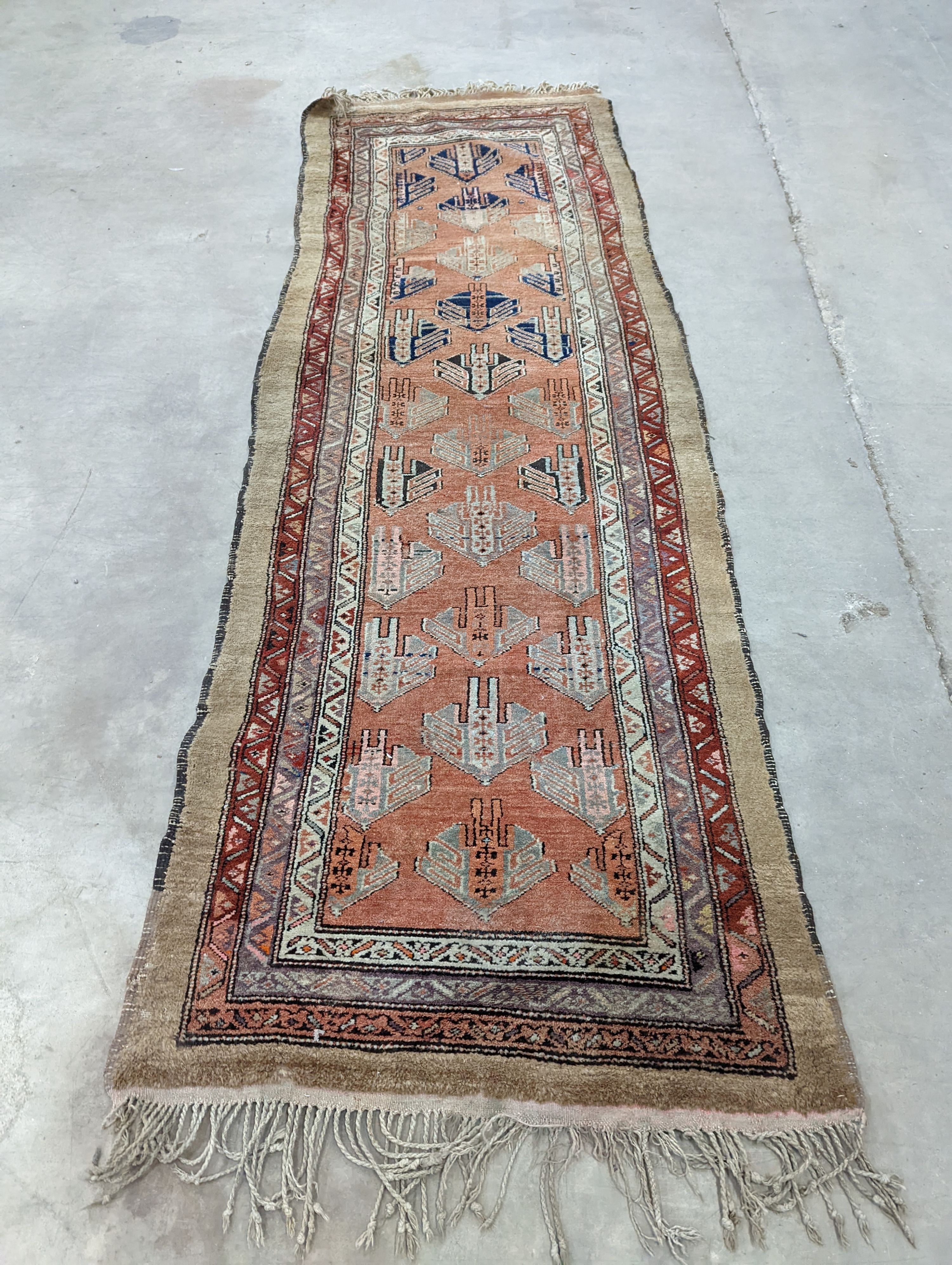 An Afghan brick red ground geometric runner and a smaller Afghan rug, larger 306 x 106cm